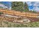 Landscaped backyard featuring a rock wall, waterfall feature and lush greenery at 17979 E Dorado Dr, Centennial, CO 80015