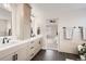 Bright bathroom featuring double vanity, sleek black hardware and a glimpse into the bedroom at 17979 E Dorado Dr, Centennial, CO 80015