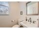Half bathroom featuring a white sink, toilet, modern fixtures, and a window with natural light at 17979 E Dorado Dr, Centennial, CO 80015