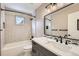 Updated bathroom featuring a modern vanity, subway tile, tub and shower combination, and a large mirror at 17979 E Dorado Dr, Centennial, CO 80015