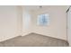 A clean, carpeted bedroom with a bright window, ready for personalization and comfortable living at 17979 E Dorado Dr, Centennial, CO 80015