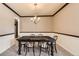 Classic dining room featuring a wooden table, chandelier, neutral color scheme, and a carpeted floor at 17979 E Dorado Dr, Centennial, CO 80015