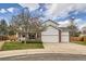 Traditional two-story home featuring a three-car garage, red brick accents, and a well-maintained front lawn at 17979 E Dorado Dr, Centennial, CO 80015