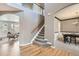 Elegant foyer with hardwood floors, a staircase with a wooden handrail, and views into the living and dining areas at 17979 E Dorado Dr, Centennial, CO 80015