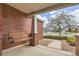 Inviting front porch with a cozy swing, red brick accents, and a view of the neighborhood street at 17979 E Dorado Dr, Centennial, CO 80015