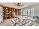 Bright game room featuring built-in bookshelves, a ping pong table, and a modern ceiling fan for entertaining at 17979 E Dorado Dr, Centennial, CO 80015