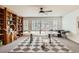 Bright and open game room features large windows, built in bookcase, and ping pong table at 17979 E Dorado Dr, Centennial, CO 80015
