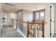 Upstairs hallway features wood and white railings with carpet and natural light coming from nearby windows at 17979 E Dorado Dr, Centennial, CO 80015
