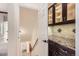 Hallway view of a dark wood display cabinet with granite countertop and tiled backsplash at 17979 E Dorado Dr, Centennial, CO 80015