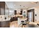 Bright kitchen features dark wood cabinets, granite countertops, and a center island with bar seating at 17979 E Dorado Dr, Centennial, CO 80015