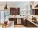Spacious kitchen with stainless steel appliances, granite counters, and wooden cabinets, leading to an outdoor deck at 17979 E Dorado Dr, Centennial, CO 80015