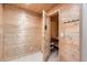 A sauna room with light, natural wood, featuring a glass door and coat hooks at 17979 E Dorado Dr, Centennial, CO 80015