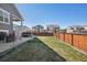 Exterior view of backyard with patio, hot tub, and green grass at 965 Peach Leaf Ln, Elizabeth, CO 80107