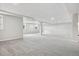 Large unfinished basement featuring carpet, white ceiling and walls, and multiple windows at 965 Peach Leaf Ln, Elizabeth, CO 80107