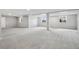 Spacious finished basement featuring neutral paint, carpet, and natural light from large windows at 965 Peach Leaf Ln, Elizabeth, CO 80107