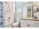 Clean and functional bathroom featuring a shower/tub combo, modern fixtures, and a vanity with ample storage at 965 Peach Leaf Ln, Elizabeth, CO 80107