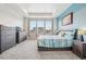 Spacious bedroom with lots of natural light, gray carpet, and contemporary furnishings at 965 Peach Leaf Ln, Elizabeth, CO 80107