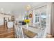 Open dining area flows into living room and kitchen, with modern lighting and sliding door to outdoor space at 965 Peach Leaf Ln, Elizabeth, CO 80107