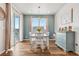 Cozy dining room features wood floors, sliding glass door to deck, and charming decor at 965 Peach Leaf Ln, Elizabeth, CO 80107