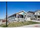 Attractive home with a corner lot with a covered front porch and lush green lawn at 965 Peach Leaf Ln, Elizabeth, CO 80107