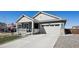 Attractive home with a covered porch and two-car garage, showcasing a well-maintained exterior at 965 Peach Leaf Ln, Elizabeth, CO 80107