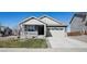 Attractive home with a covered front porch, two-car garage, and a well-maintained lawn at 965 Peach Leaf Ln, Elizabeth, CO 80107