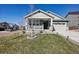 Charming single-Gathering home featuring a well-manicured lawn, covered porch, and an attached two-car garage at 965 Peach Leaf Ln, Elizabeth, CO 80107