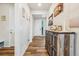 Hallway view with wood flooring, stylish furnishings, and light-colored walls, creating a warm, welcoming entry at 965 Peach Leaf Ln, Elizabeth, CO 80107