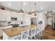 Bright, open kitchen features granite countertops, an island with seating, and modern pendant lighting at 965 Peach Leaf Ln, Elizabeth, CO 80107