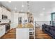 Spacious kitchen with granite counters, a large island, stainless steel appliances, and hardwood floors at 965 Peach Leaf Ln, Elizabeth, CO 80107