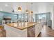 Open-concept kitchen with granite countertops, a center island, and seamless flow to the living and dining areas at 965 Peach Leaf Ln, Elizabeth, CO 80107