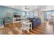 Bright living room showcases blue walls, natural light, and seamless flow to the dining area at 965 Peach Leaf Ln, Elizabeth, CO 80107