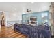 Open-concept living space featuring wood floors, blue accent wall, cozy seating, and natural light at 965 Peach Leaf Ln, Elizabeth, CO 80107
