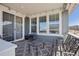 Inviting covered patio features stylish metal furniture and pleasant neighborhood views through large windows at 965 Peach Leaf Ln, Elizabeth, CO 80107