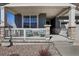 Inviting front porch featuring stone accents, comfortable seating, and a lovely view of the neighborhood at 965 Peach Leaf Ln, Elizabeth, CO 80107