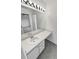 Bright bathroom with a vanity area, large mirror, and ample lighting at 5521 Spruce Ave, Castle Rock, CO 80104