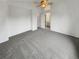 Carpeted bedroom featuring a ceiling fan and bathroom access at 5521 Spruce Ave, Castle Rock, CO 80104