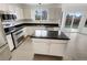 Modern kitchen featuring white cabinets, stainless steel appliances, and granite countertops at 5521 Spruce Ave, Castle Rock, CO 80104