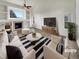 Bright living room features a fireplace, built-in shelves, and stylish decor, virtually staged at 5521 Spruce Ave, Castle Rock, CO 80104