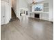 Bright and spacious living room with fireplace, stairs, and hardwood floors at 5521 Spruce Ave, Castle Rock, CO 80104