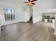 Bright open floor plan features wood floors, high ceilings, and access to the kitchen at 5521 Spruce Ave, Castle Rock, CO 80104