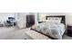 Bright bedroom featuring a large window, a work desk and a comfortable bed with patterned bedding at 5129 Pasadena Way, Broomfield, CO 80023