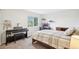 Comfortable bedroom featuring a window, a piano, a work space, and a cozy bed at 5129 Pasadena Way, Broomfield, CO 80023