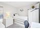 Well-lit bedroom with white furniture, including a bed with built-in storage, dresser, and desk area at 5129 Pasadena Way, Broomfield, CO 80023