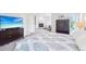 Bright bedroom with a large bed, TV, fireplace, and a big window allowing ample natural light at 5129 Pasadena Way, Broomfield, CO 80023