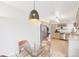 Cozy dining area with modern lighting, glass table, and easy access to the kitchen at 5129 Pasadena Way, Broomfield, CO 80023