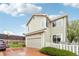 A view of this lovely home's exterior, including a two-car garage and well-maintained lawn at 5129 Pasadena Way, Broomfield, CO 80023