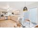 Open kitchen featuring stainless steel appliances, light wood cabinetry, and eat-in breakfast nook at 5129 Pasadena Way, Broomfield, CO 80023