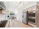 Modern kitchen with stainless steel appliances, light cabinetry, and adjacent dining area at 5129 Pasadena Way, Broomfield, CO 80023