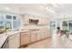 Bright kitchen featuring beige cabinets, stainless appliances, and tile flooring adjacent to dining area at 5129 Pasadena Way, Broomfield, CO 80023